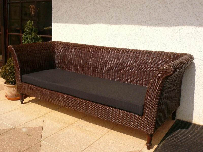 Black bench cushion on rattan bench